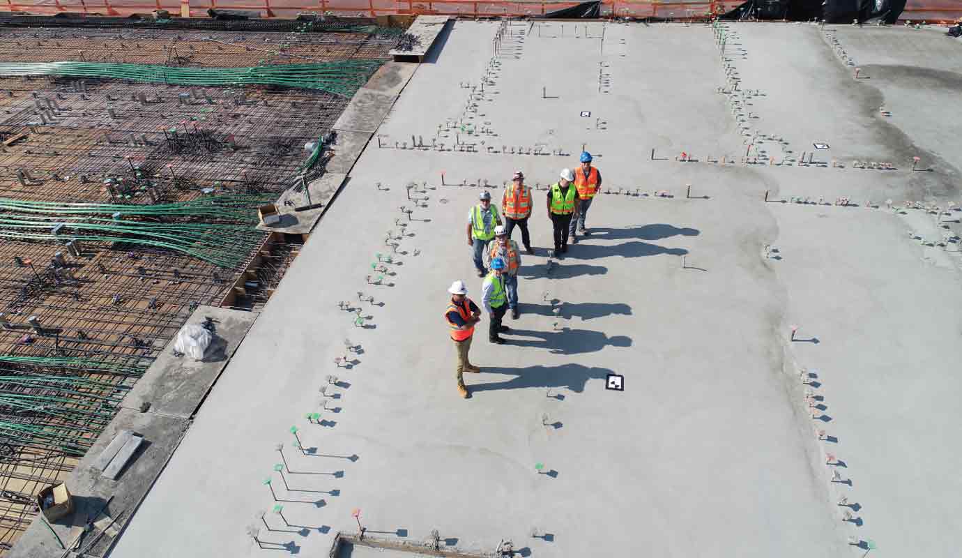 Dricrete crew walking a waterproofed concrete slab